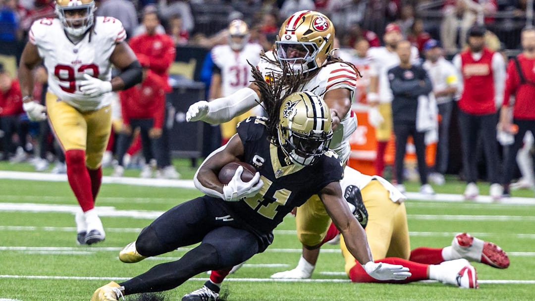 Sep 14, 2025; New Orleans, Louisiana, USA;  New Orleans Saints running back Alvin Kamara (41) runs against San Francisco 49ers linebacker Fred Warner (54) during the second half at Caesars Superdome. Mandatory Credit: Stephen Lew-Imagn Images