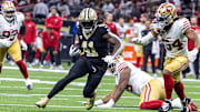 Sep 14, 2025; New Orleans, Louisiana, USA;  New Orleans Saints running back Alvin Kamara (41) runs against San Francisco 49ers linebacker Fred Warner (54) during the second half at Caesars Superdome. Mandatory Credit: Stephen Lew-Imagn Images