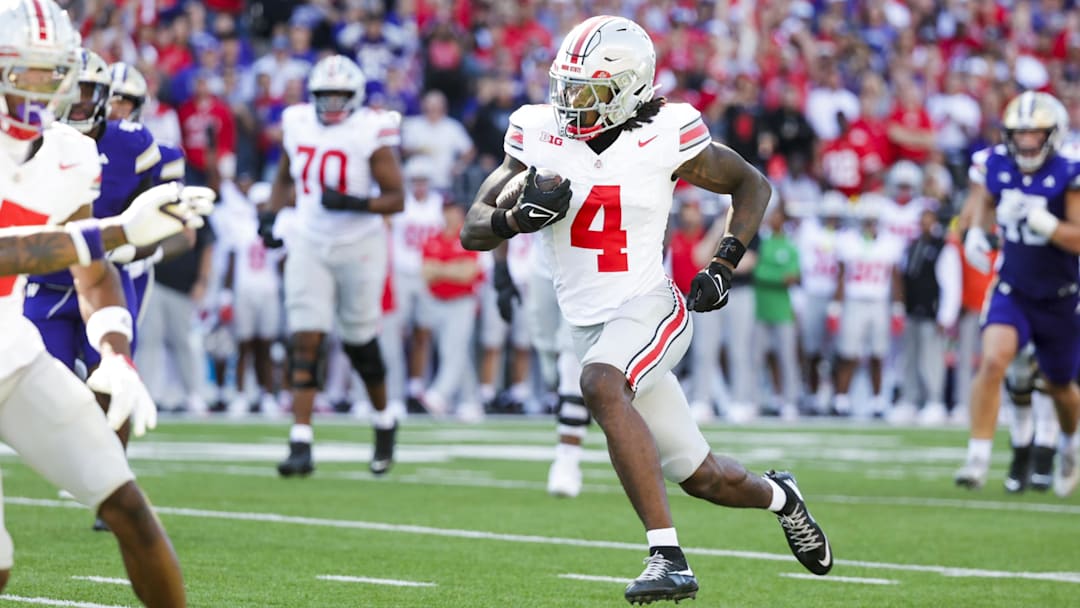 Sep 27, 2025; Seattle, Washington, USA; Ohio State Buckeyes wide receiver Jeremiah Smith (4) runs for a touchdown after catching a pass against the Washington Huskies during the second quarter at Husky Stadium. Mandatory Credit: Joe Nicholson-Imagn Images