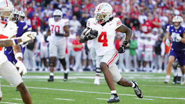 Sep 27, 2025; Seattle, Washington, USA; Ohio State Buckeyes wide receiver Jeremiah Smith (4) runs for a touchdown after catching a pass against the Washington Huskies during the second quarter at Husky Stadium. Mandatory Credit: Joe Nicholson-Imagn Images