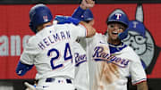 July 21, 2025; Arlington, Texas, USA; Texas Rangers outfielder Micheal Helman (24) elbow bumps Texas Rangers designated hitter Cody Freeman (39) after hitting a three-run home run at Globe Life Field. Helman collected his first MLB home run and Freeman his first MLB hit both in the fifth inning against the Athletics. 