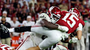 Nov 15, 2025; Tuscaloosa, Alabama, USA;  Alabama Crimson Tide quarterback Ty Simpson (15) is tackled by Oklahoma Sooners defensive lineman David Stone (0) during the third quarter at Saban Field at Bryant-Denny Stadium. Mandatory Credit: David Leong-Imagn Images