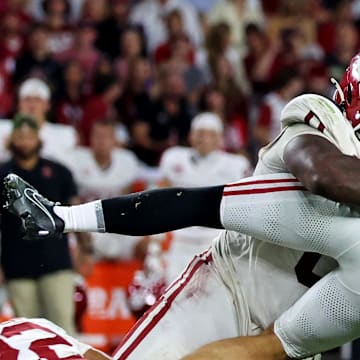 Nov 15, 2025; Tuscaloosa, Alabama, USA;  Alabama Crimson Tide quarterback Ty Simpson (15) is tackled by Oklahoma Sooners defensive lineman David Stone (0) during the third quarter at Saban Field at Bryant-Denny Stadium. Mandatory Credit: David Leong-Imagn Images