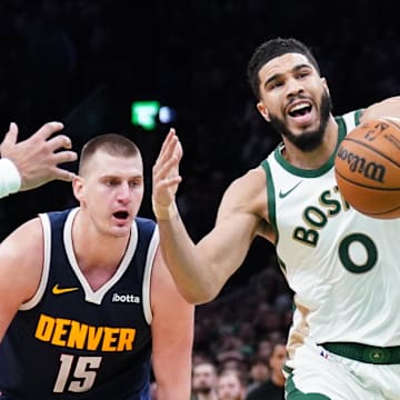 Jan 19, 2024; Boston, Massachusetts, USA; Boston Celtics forward Jayson Tatum (0) works for the ball against Denver Nuggets center Nikola Jokic (15), guard Jamal Murray (27) and guard Kentavious Caldwell-Pope (5) in the last seconds of the game at TD Garden. 