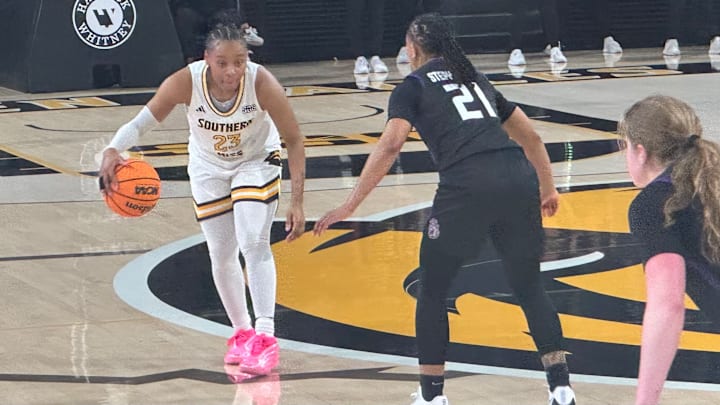Southern Miss Lady Eagles guard Hayleigh Breland (#23) brings the ball up the floor against James Madison.