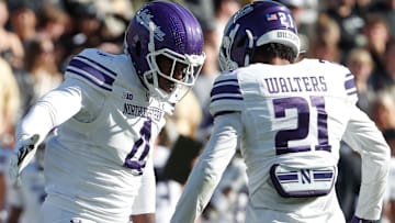 Northwestern Wildcats defensive lineman Anto Saka (4) and Northwestern Wildcats defensive back Damon Walters (21) celebrate after a defensive stop Saturday, Nov. 2, 2024, during the NCAA football game against the Purdue Boilermakers at Ross-Ade Stadium in West Lafayette, Ind. Northwestern Wildcats won 26-20.