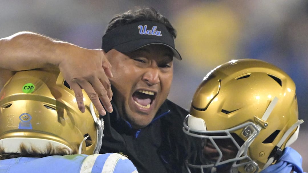 Nov 8, 2024; Pasadena, California, USA; UCLA Bruins defensive coordinator Ikaika Malloe, center, celebrates with linebacker Carson Schwesinger (49) defensive back Jaylin Davies (6) after an interception in the second half against the Iowa Hawkeyes at the Rose Bowl. Mandatory Credit: Jayne Kamin-Oncea-Imagn Images Nov 8, 2024; Pasadena, California, USA; UCLA Bruins defensive coordinator Ikaika Malloe, center, celebrates with linebacker Carson Schwesinger (49) defensive back Jaylin Davies (6) after an interception in the second half against the Iowa Hawkeyes at the Rose Bowl. Mandatory Credit: Jayne Kamin-Oncea-Imagn Images