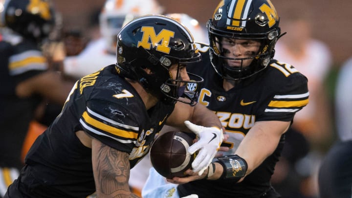 Missouri quarterback Brady Cook (12) hands the ball off to running back Cody Schrader (7) during their NCAA college football game against Tennessee on Saturday, November 11, 2023 in Columbia, MO.