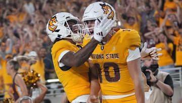 Arizona State quarterback Sam Leavitt (10) celebrates a touchdown with teammate Jordyn Tyson (0).