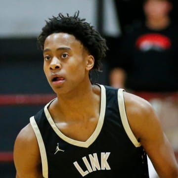 Link Academy's Tre Johnson moves the ball downcourt as the Lions took on the Central Bulldogs in The Pit at Central High School on Tuesday, Nov. 28, 2023.