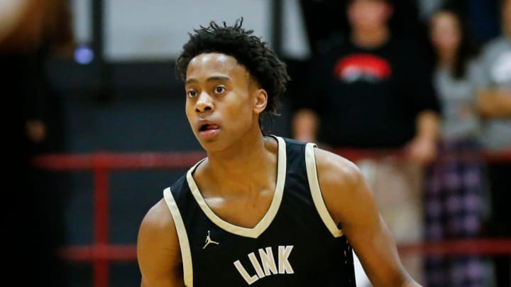 Link Academy's Tre Johnson moves the ball downcourt as the Lions took on the Central Bulldogs in The Pit at Central High School on Tuesday, Nov. 28, 2023.