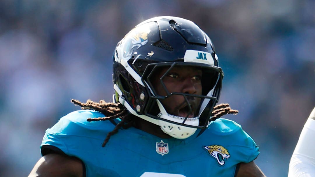 Jacksonville Jaguars linebacker Devin Lloyd celebrates a fumble recovery with cornerback Montaric Brown.