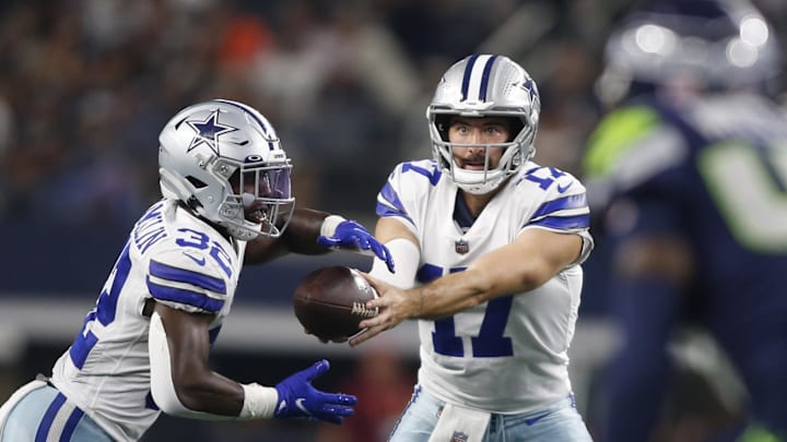 Aug 26, 2022; Arlington, Texas, USA; Dallas Cowboys quarterback Ben DiNucci (17) hands off to running back Aaron Shampklin (32) in the fourth quarter against the Seattle Seahawks at AT&T Stadium. Mandatory Credit: Tim Heitman-Imagn Images