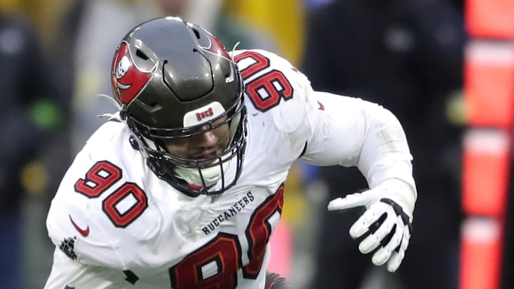 Dec 17, 2023; Green Bay, Wisconsin, USA; Tampa Bay Buccaneers defensive end Logan Hall (90) recovers a fourth quarter fumble against the Green Bay Packers during their football game at Lambeau Field. Mandatory Credit: William Glasheen-Imagn Images