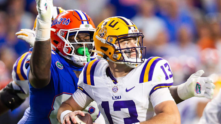 Florida Gators defensive lineman Caleb Banks (88) causes a fumble as he strips the ball from LSU Tigers quarterback Garrett Nussmeier (13) during the second half at Ben Hill Griffin Stadium in Gainesville, FL on Saturday, November 16, 2024. The Gators defeated the Tigers 27-16. [Doug Engle/Gainesville Sun]