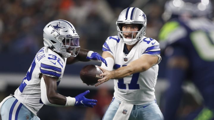 Aug 26, 2022; Arlington, Texas, USA; Dallas Cowboys quarterback Ben DiNucci (17) hands off to running back Aaron Shampklin (32) in the fourth quarter against the Seattle Seahawks at AT&T Stadium. Mandatory Credit: Tim Heitman-USA TODAY Sports