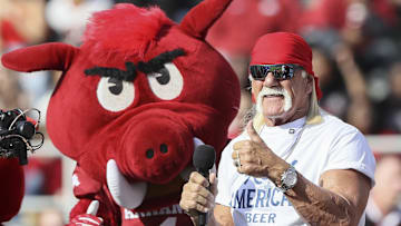 Nov 16, 2024; Fayetteville, Arkansas, USA; Hulk Hogan and an Arkansas Razorbacks mascot hype the crowd during the first quarter against the Texas Longhorns at Donald W. Reynolds Razorback Stadium. Mandatory Credit: Nelson Chenault-Imagn Images