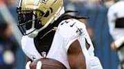 Oct 19, 2025; Chicago, Illinois, USA; New Orleans Saints running back Alvin Kamara (41) rushes the ball against the Chicago Bears during the first quarter at Soldier Field. 