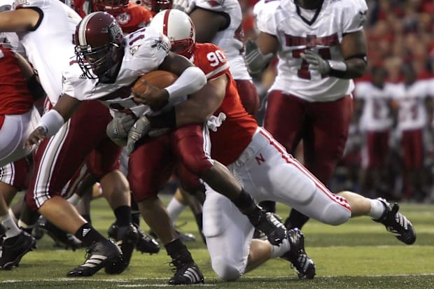 Nebraska Cornhuskers defensive end Adam Carriker goes for the sack on Troy Trojans quarterback Omar Haugabook.
