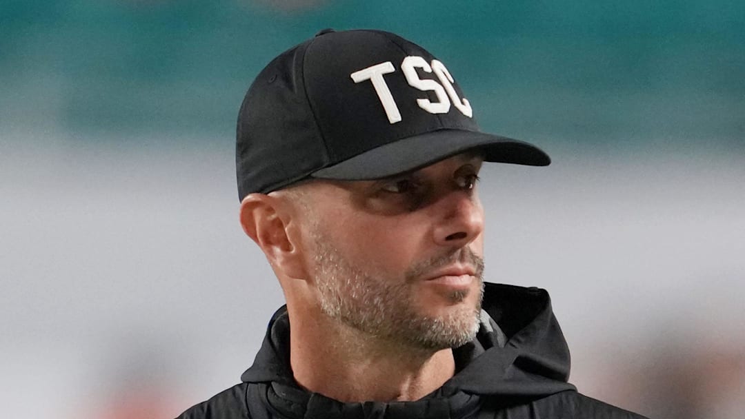 Jan 19, 2026; Miami Gardens, FL, USA; Las Vegas Raiders general manager John Spytek walks on the sideline before the CFP National Championship college football game between the Indiana Hoosiers and the Miami Hurricanes at Hard Rock Stadium. Mandatory Credit: Kirby Lee-Imagn Images