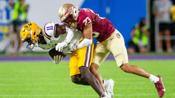 Florida State Seminoles defensive back Fentrell Cypress II (23) tackles LSU Tigers wide receiver Brian Thomas Jr. (11) during a game at Camping World Stadium on Sunday, Sept. 3, 2023.
