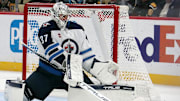 Nov 22, 2024; Pittsburgh, Pennsylvania, USA; Winnipeg Jets goaltender Connor Hellebuyck (37) makes as save against the Pittsburgh Penguins during the third period at PPG Paints Arena. Mandatory Credit: Charles LeClaire-Imagn Images