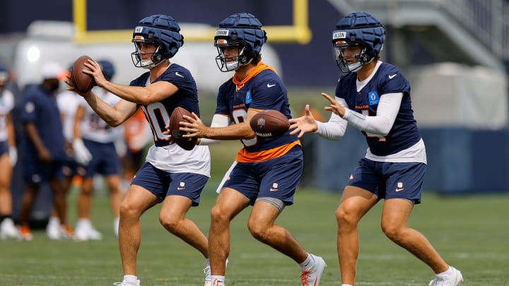 Denver Broncos quarterbacks Bo Nix, Jarrett Stidham, and Zach Wilson run a drill at training camp. 