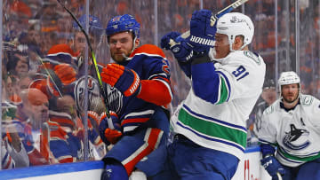 Vancouver Canucks defensemen Nikita Zadorov (91) checks Edmonton Oilers Forward