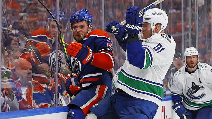 Vancouver Canucks defensemen Nikita Zadorov (91) checks Edmonton Oilers Forward
