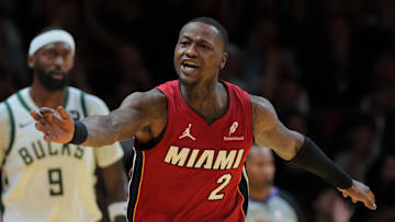 Nov 26, 2024; Miami, Florida, USA; Miami Heat guard Terry Rozier (2) reacts toward referee Tom Washington (49) after shooting the basketball against the Milwaukee Bucks during the fourth quarter at Kaseya Center. Mandatory Credit: Sam Navarro-Imagn Images