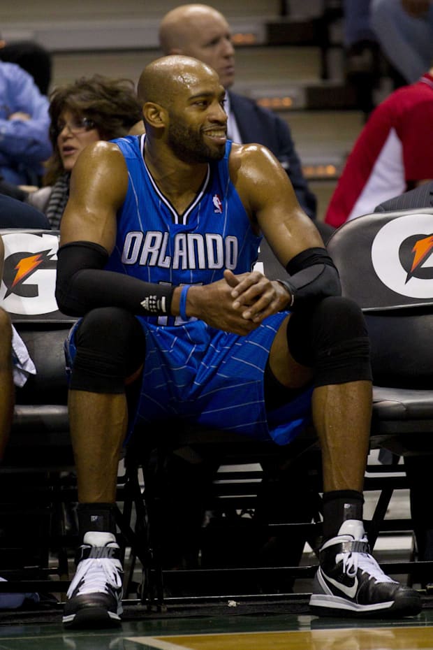 Orlando Magic guard Vince Carter looks on from the bench