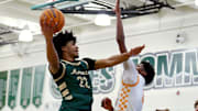 Kellen Hampton of Moreau Catholic drives to the hoop defended by a Riverside Poly player during the 27th MLK Classic at De La Salle High School. Hampton had 40 points Tuesday in a wild 84-78 overtime win at Dougherty Valley.