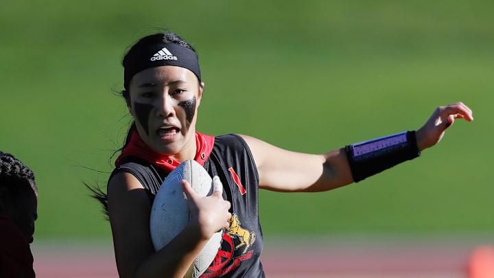 Lincoln senior quarterback Anya Tom tries to get around a defender in her team's 14-2 win over Lowell for the San Francisco Section championship 11/28/2024 at Kezar Stadium