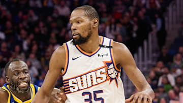 Dec 28, 2024; San Francisco, California, USA; Phoenix Suns forward Kevin Durant (35) controls the ball against Golden State Warriors forward Draymond Green (23) during the third quarter at Chase Center. Mandatory Credit: Robert Edwards-Imagn Images