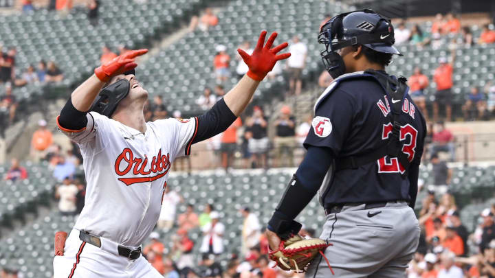 Jun 25, 2024; Baltimore, Maryland, USA; Baltimore Orioles shortstop Gunnar Henderson (2) reacts after hitting a first inning home run as Cleveland Guardians catcher Bo Naylor (23) looks on at Oriole Park at Camden Yards. 