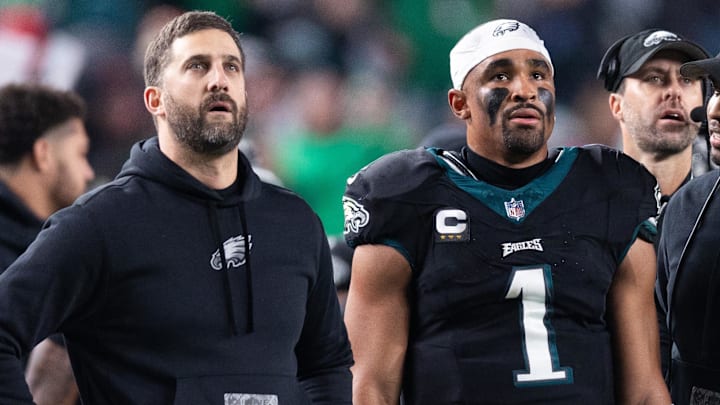 Dec 25, 2023; Philadelphia, Pennsylvania, USA; Philadelphia Eagles head coach Nick Sirianni (L) and quarterback Jalen Hurts (1) and offensive coordinator Brian Johnson (R) talk during the second quarter against the New York Giants at Lincoln Financial Field. Mandatory Credit: Bill Streicher-Imagn Images