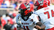 Sep 20, 2025; Durham, North Carolina, USA;  North Carolina State Wolfpack quarter back CJ Bailey (11) runs the ball against the Duke Blue Devils during the first quarter at Wallace Wade Stadium. Mandatory Credit: Zachary Taft-Imagn Images