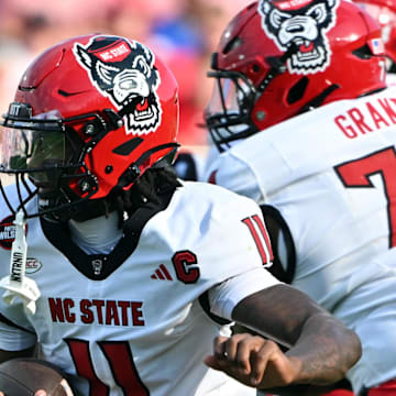 Sep 20, 2025; Durham, North Carolina, USA;  North Carolina State Wolfpack quarter back CJ Bailey (11) runs the ball against the Duke Blue Devils during the first quarter at Wallace Wade Stadium. Mandatory Credit: Zachary Taft-Imagn Images