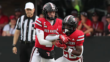 Sep 13, 2025; Lubbock, Texas, USA;  Texas Tech Red Raiders quarterback Behren Morton (2) hands the ball in the first half to running back J’Koby Williams (20) in the game against the Oregon State Beavers at Jones AT&T Stadium. Mandatory Credit: Michael C. Johnson-Imagn Images