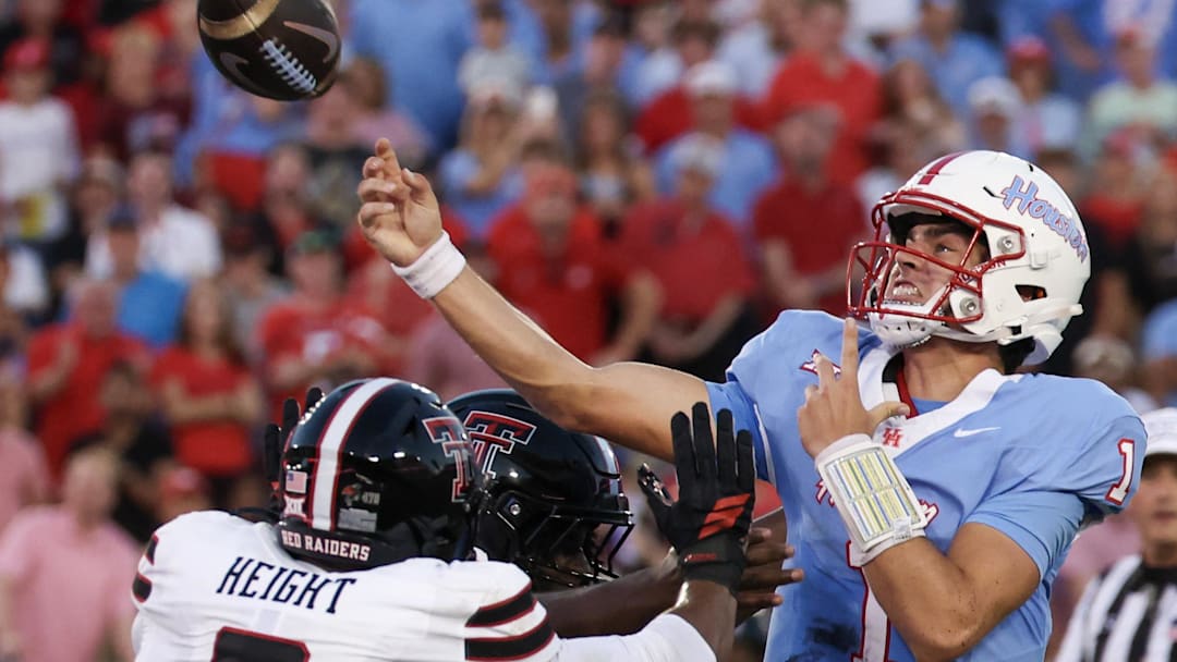 Oct 4, 2025; Houston, Texas, USA; Houston Cougars quarterback Conner Weigman (1) passes while being rushed by Texas Tech Red Raiders defensive end Romello Height (9) in the first half at TDECU Stadium. Mandatory Credit: Thomas Shea-Imagn Images