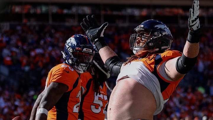 Oct 23, 2022; Denver, Colorado, USA; Denver Broncos guard Quinn Meinerz (77) celebrates the touchdown of running back Latavius Murray (28) in the first quarter against the New York Jets at Empower Field at Mile High. 