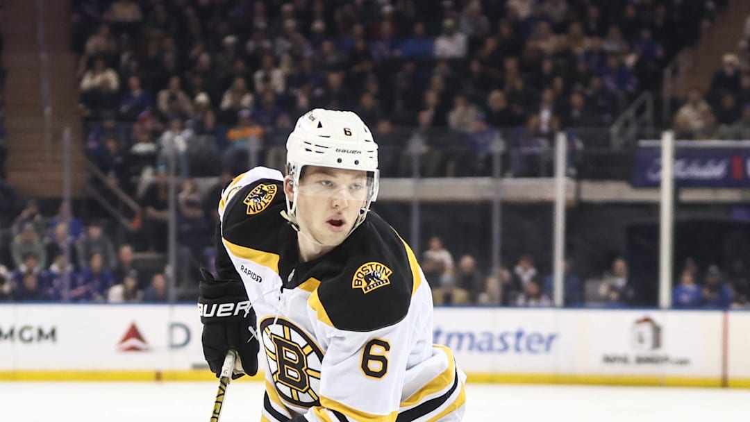 Jan 2, 2025; New York, New York, USA;  Boston Bruins defenseman Mason Lohrei (6) controls the puck in the first period against the New York Rangers at Madison Square Garden. Mandatory Credit: Wendell Cruz-Imagn Images