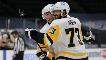 Feb 6, 2021; Uniondale, New York, USA; Pittsburgh Penguins defenseman Pierre-Olivier Joseph (73) celebrates his goal against the New York Islanders with defenseman Kris Letang (58) during the first period at Nassau Veterans Memorial Coliseum. Mandatory Credit: Brad Penner-Imagn Images