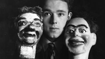 An unidentified man (possibly John Logie Baird) holds Stooky Bill (left) and another ventriloquist’s dummy used in Baird’s first TV transmissions.