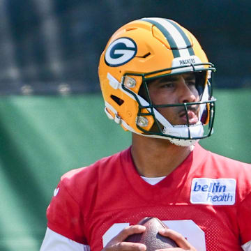 Green Bay Packers quarterback Jordan Love drops back to pass under the supervision of coach Matt LaFleur at minicamp.