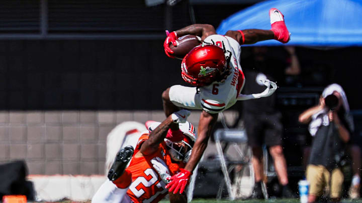 Oct 4, 2025; Tucson, Arizona, USA; Arizona Wildcats linebacker Taye Brown (6) leaps over Oklahoma State Cowboys cornerback Raymond Gay II (27) during the second quarter at Arizona Stadium. Mandatory Credit: Aryanna Frank-Imagn Images