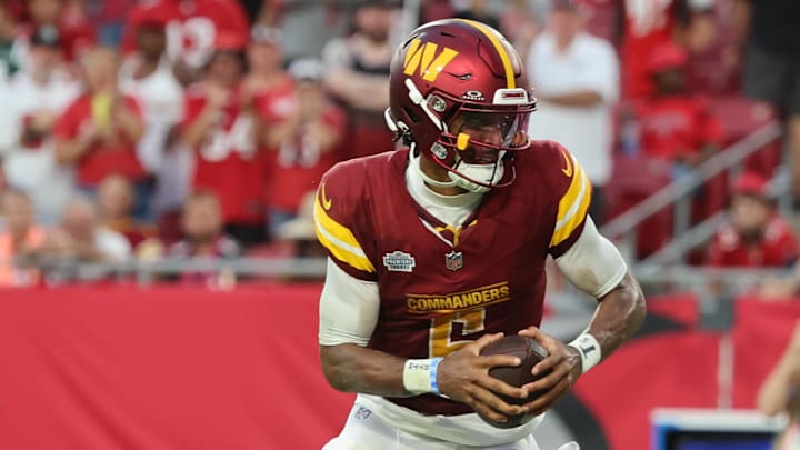 Sep 8, 2024; Tampa, Florida, USA;  Washington Commanders quarterback Jayden Daniels (5) runs the ball in for a touchdown against the Tampa Bay Buccaneers during the second half at Raymond James Stadium. Mandatory Credit: Kim Klement Neitzel-Imagn Images