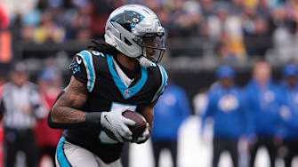 Nov 30, 2025; Charlotte, North Carolina, USA; Carolina Panthers running back Rico Dowdle (5) rushes during the first quarter against the Los Angeles Rams at Bank of America Stadium. 