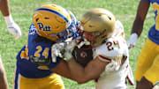 Oct 4, 2025; Pittsburgh, Pennsylvania, USA;  Pittsburgh Panthers linebacker Cameron Lindsey (24 left) tackles Boston College Eagles running back Bo MacCormack III (24 right) during the fourth quarter at Acrisure Stadium. Mandatory Credit: Charles LeClaire-Imagn Images