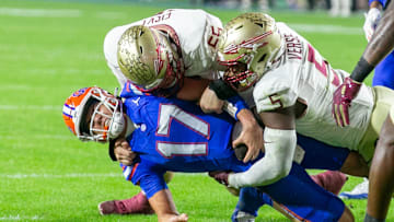 Florida Gators quarterback Max Brown (17) gets stopped by Florida State Seminoles defensive lineman Jared Verse (5) and Florida State Seminoles defensive lineman Braden Fiske (55) during first half action as Florida takes on Florida State at Steve Spurrier Field at Ben Hill Griffin Stadium in Gainesville, FL on Saturday, November 25, 2023. [Alan Youngblood/Gainesville Sun]